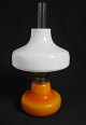 Holmegård Glass 
oil lamp, 
1960s. In 
orange glass 
with white 
cover. Burner 
in brass. H.: 
30 cm. ...