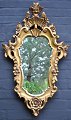 Gilded rococo 
mirror, 20th 
century. 
Decorations 
with rosettes, 
foliage and 
flowers. 
Height: 81 ...