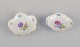 Meissen, Germany. Two porcelain bowls hand-painted with polychrome flowers. Gold 
rim.