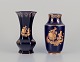 Limoges, France. Two porcelain vases decorated with 22-karat gold leaf and beautiful royal blue ...