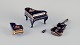 Limoges, 
France. Four 
porcelain 
musical 
instruments ...