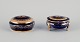 Limoges, France. Two lidded porcelain jars decorated with 22-karat gold leaf and 
featuring a beautiful royal blue glaze with a Scène galante.