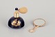 Limoges, 
France. 
Porcelain 
perfume 
atomizer and 
makeup mirror 
decorated with 
22-karat gold 
leaf ...
