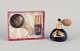 Limoges, 
France. Two 
porcelain 
perfume 
atomizers and a 
makeup mirror, 
decorated with 
22-karat ...