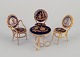 Limoges, 
France. 
Miniature table 
and chairs made 
of brass and 
porcelain, 
decorated with 
22-karat ...