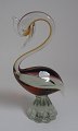 Venezian bird 
in glass, 
ca.1960. In 
purpel/ 
yellowish glass 
with overlay in 
clear glass. 
Foot in ...