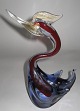 Venezian glass, 
1960s, in the 
form of a 
"grebe". Inside 
red glass mass 
with violet 
overcoating; 
...