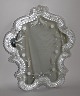 Venetian 
mirror, Italy, 
20th century. 
Mirror glass 
with grindings, 
rim made with 
rocailles and 
...