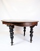 Mahogany dining 
table with 
round legs with 
carvings from 
around the 
1880s.
Dimensions in 
cm: ...