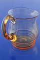 Holmegaard Glasworks, Beautiful amber-coloured water jug, height at handle 14.8 cm. 90.0 cl. No ...