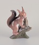 Bing & Grøndahl. Rare porcelain figurine of a squirrel on a tree stump.Approximately from the ...
