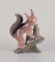 Bing & 
Grøndahl. Rare 
porcelain 
figurine of a 
squirrel on a 
tree stump.
Approximately 
from the ...