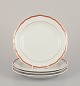 Meissen, Germany. A set of four plates. Decorated with coral red and 
gold-colored trim. Art Deco.