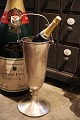 Old French champagne cooler on foot in metal with handle and a fine patina. Height: 49cm. Dia.: ...