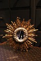 Decorative, old French sun mirror in wood with both gold and silver coatings and with a very ...