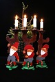 3 small old 
Christmas elves 
in painted wood 
with a fine 
patina, 
each holding a 
small Christmas 
...