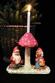 Old Christmas 
decoration in 
form of a pair 
of elves 
standing under 
a mushroom with 
room for a ...