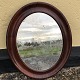 Older mirror in 
mahogany 
veneered frame. 
Heavy 
patination on 
the mirror 
glass. 59x48 cm