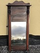 Older mirror in a mahogany veneer frame, some age-related traces of use. Dimensions: 85x40 cm