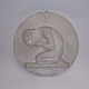 Round plaque in 
plaster with a 
motif of a 
crying boy on 
his knees, 
hiding his face 
in his hands. 
...