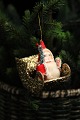 Old Christmas 
tree decoration 
in the form of 
Santa Claus in 
a gold sleigh. 
Made of 
cardboard ...