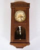 Wall clock in an oak box with pillared sides and a beautiful dial combines functionality with ...