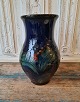 Danico large 
midnight blue 
vase decorated 
with green 
leaves and red 
berries 
Stamped: ...