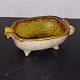 Small ceramic 
frying pan. 
Shaped like a 
pig. Stsnding 
on four feet. 
Glazed inside. 
Appears in ...