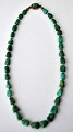 Necklace with 
malachites and 
clasp in 
sterling silver 
925. 20th 
century L: 45 
cm.