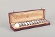 Hallberg, 
Stockholm, 
Royal Swedish 
Court Supplier. 
A set of twelve 
glass coasters 
in 830 silver. 
...