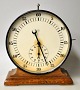 Junghan 
timekeeping 
clock, approx. 
1930. Germany. 
On a polished 
oak base. With 
60 minute hand 
...