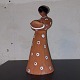 Ceramic figure 
I of a woman 
who serves as a 
candlestick. 
Partially 
glazed in white 
and black. ...