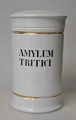 Apothecary jar 
in porcelain. 
19th century 
White porcelain 
with two gilt 
trims. Black 
text ...