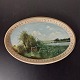 Painting on 
oval plate. 
Painted 
landscape motif 
on terracotta 
plate from 
Peter Ipsen, 
...