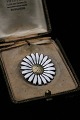 Old Marguerite / Daisy brooch in sterling silver and white enamel 
from A. Michaelsen. 
Dia.: 4cm...