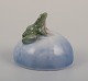 Royal 
Copenhagen 
porcelain 
figurine. Frog 
on a stone.
Early 1900s.
Model number 
507.
In ...