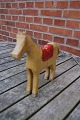 Wooden horse of 
painted wood 
and with red 
saddle from 
first half of 
20th Century. 
In a good used 
...