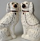 A pair of 
Staffordshire 
dogs, 19th 
century 
England. 
Earthenware. 
Painted and 
gilded. H.: 30 
...