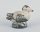 Royal 
Copenhagen 
figurine in 
stoneware of an 
eider duck.
Glaze in 
shades of 
blue-green and 
...