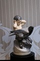 Royal 
Copenhagen 
porcelain 
figure of Faun 
and crow. 
Decoration 
number: 2113. 
1.sort. Height: 
...