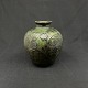Height 18 cm.
Nice vase from 
Kähler 
decorated with 
black leaves on 
the green 
background.
It ...