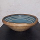 Old bowl in 
pottery.  Blue 
glaze inside 
with decorative 
light stripes. 
Age-related 
signs of wear 
...