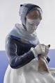 Royal 
Copenhagen 
porcelain, 
figurine. Royal 
Copenhagen 
Woman knitting 
no. 1317. 
Height 23 cm. 9 
...