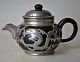 Chinese 
stoneware 
teapot with 
pewter 
mounting, 
approx. 1930. 
Decoration of 
kites. Stamped 
on the ...