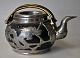 Chinese 
stoneware 
teapot with 
pewter 
mounting, 
approx. 1930. 
Decorated with 
dragons, script 
and ...