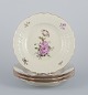 Royal 
Copenhagen 
"Frijsenborg". 
Four dinner 
plates in 
hand-painted 
porcelain with 
floral motifs 
...