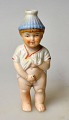 Bisquit figure 
- cold painted, 
19th century 
Germany. A 
little peeing 
boy with a top 
hat. H: 10.5 
cm.