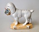 Porcelain 
figure of 
poodle dog with 
basket, 19th 
century ...