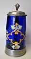 German drinking 
mug, 19th 
century. Cobalt 
blue glass 
decorated with 
enamel colors 
in the form of 
...