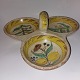 Serving dish 
with handle in 
ceramic painted 
with fruits and 
flowers. Some 
traces of use 
on the ...